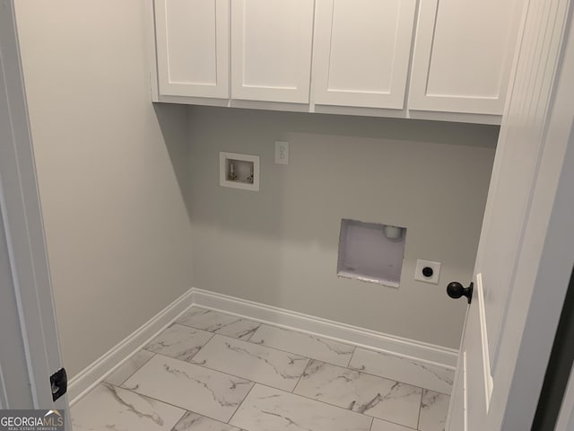 clothes washing area with hookup for a washing machine, electric dryer hookup, and cabinets