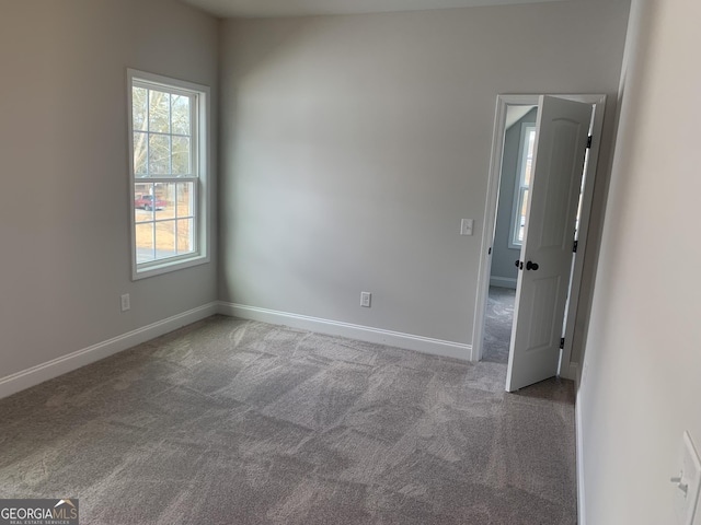 unfurnished room featuring carpet