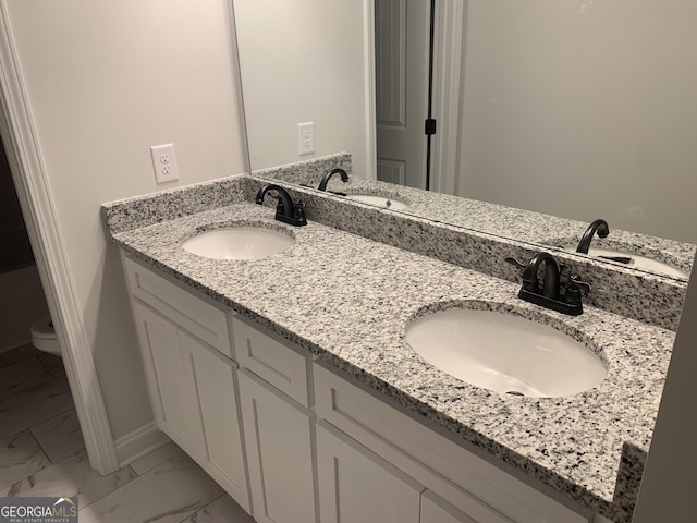 bathroom with vanity and toilet