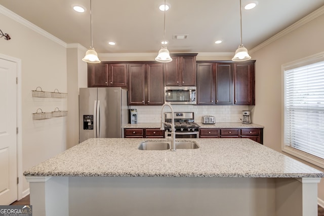 kitchen featuring light stone counters, stainless steel appliances, and hanging light fixtures