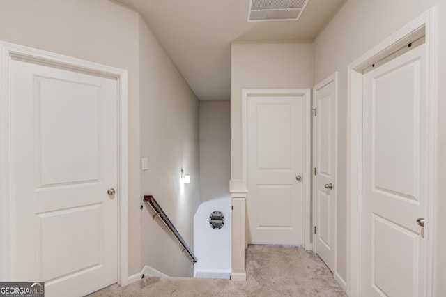 corridor featuring light colored carpet