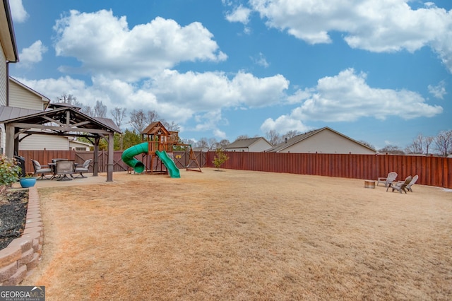 view of yard with a gazebo, a playground, and a patio area