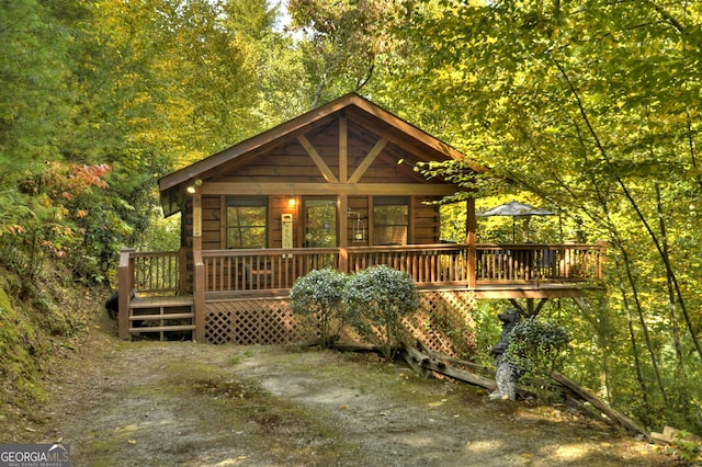 log-style house featuring a deck