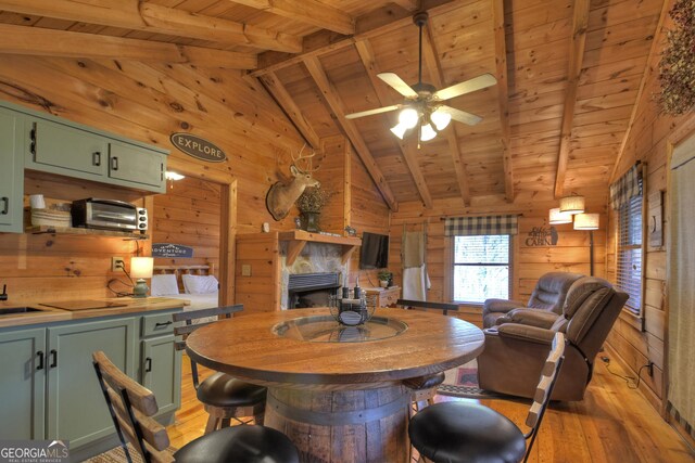 dining area featuring vaulted ceiling with beams, wood ceiling, and light hardwood / wood-style flooring