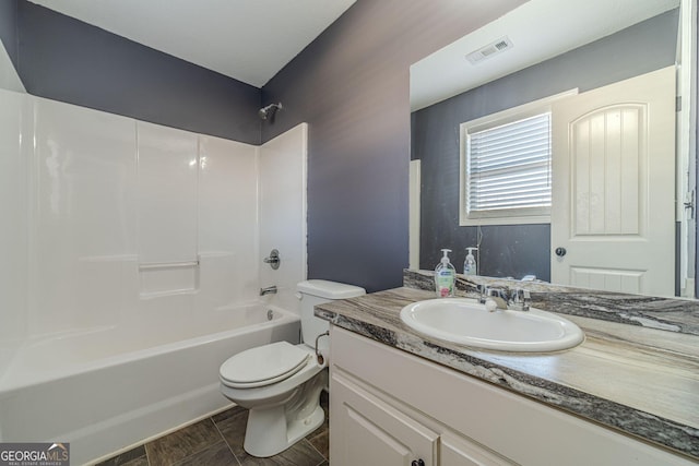 full bathroom with vanity, washtub / shower combination, and toilet