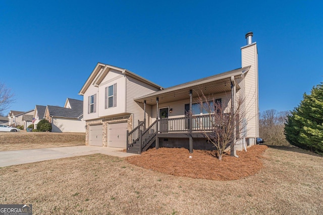 view of front of house featuring a garage, a front yard, and covered porch