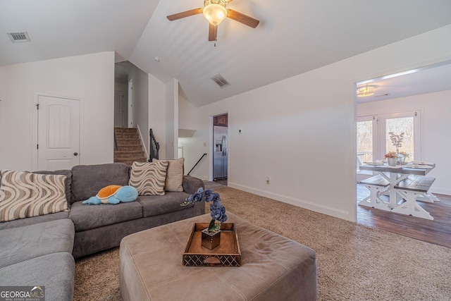 carpeted living room featuring vaulted ceiling and ceiling fan