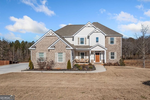 craftsman house with a porch and a front lawn