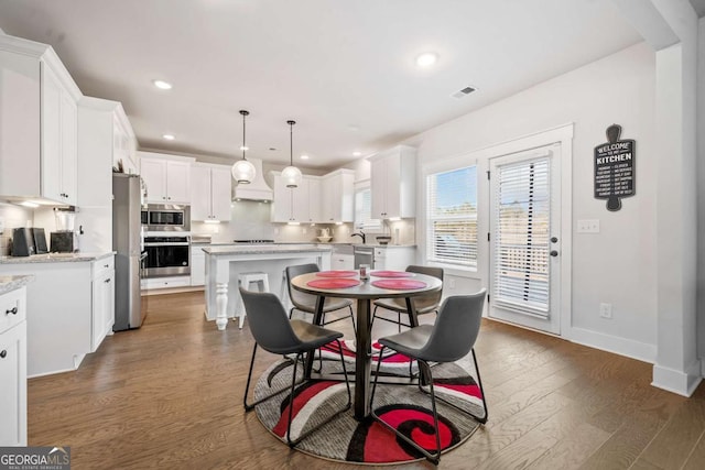 dining room with dark hardwood / wood-style floors