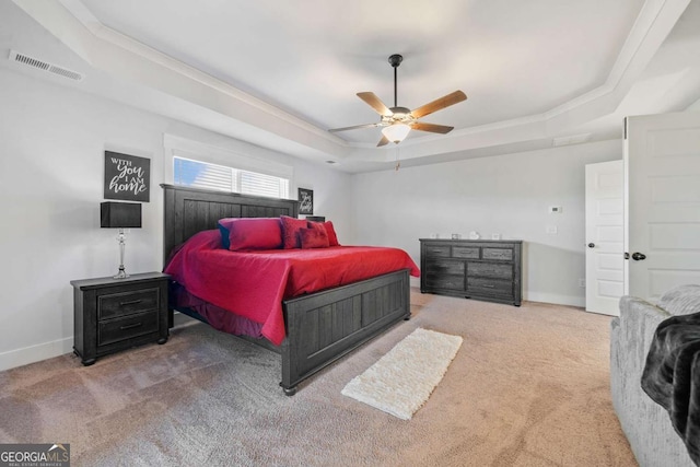 bedroom with carpet floors, ornamental molding, a raised ceiling, and ceiling fan