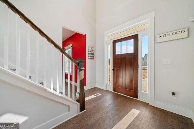 foyer with a wealth of natural light and dark wood-type flooring