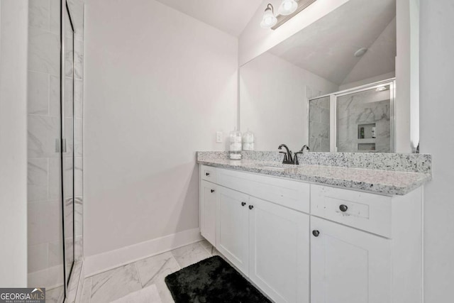 bathroom with vaulted ceiling, vanity, and a shower with shower door