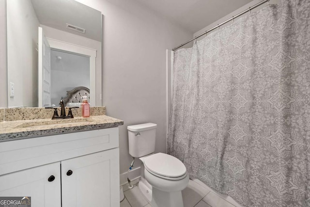 bathroom with vanity, toilet, and tile patterned flooring