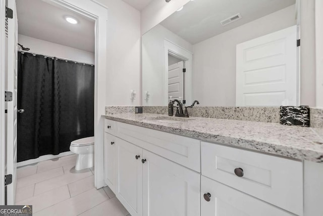 bathroom with vanity, tile patterned floors, and toilet