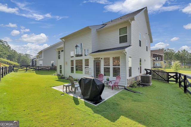 back of property with a yard, central AC unit, and a patio area