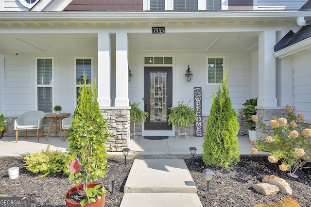 view of exterior entry with a porch