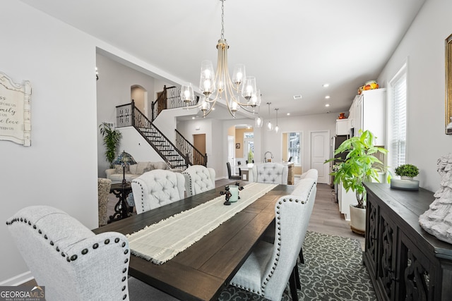 dining area featuring hardwood / wood-style floors and a chandelier