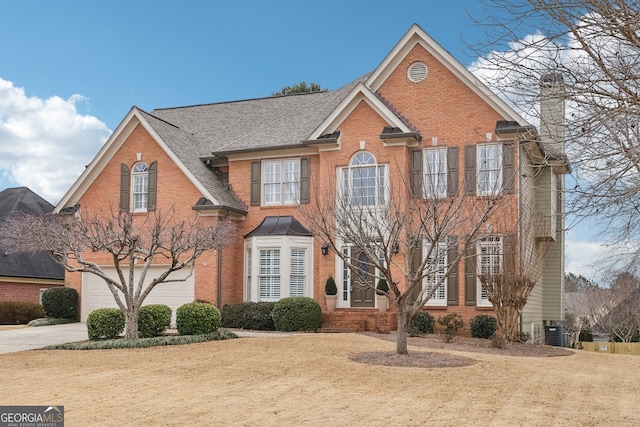 view of front of house with a garage and a front lawn