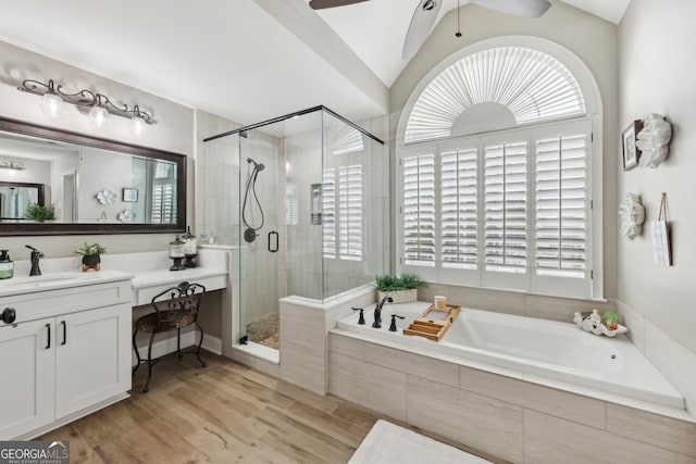 bathroom featuring lofted ceiling, vanity, independent shower and bath, and a wealth of natural light