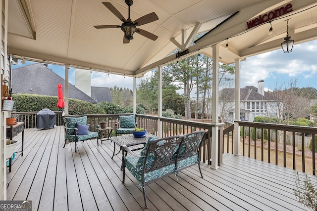 wooden deck featuring an outdoor living space, area for grilling, and ceiling fan