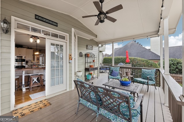 wooden terrace featuring ceiling fan