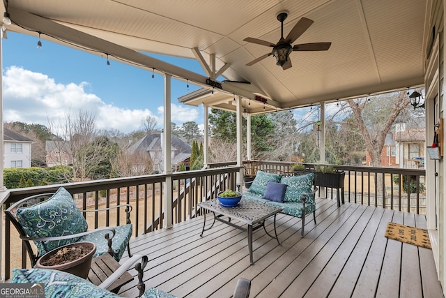 wooden deck with an outdoor hangout area and ceiling fan