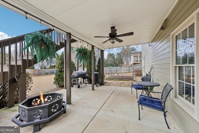 view of patio featuring a grill, ceiling fan, and an outdoor fire pit