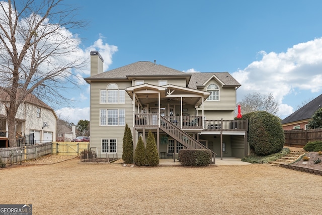 back of house with a deck, ceiling fan, and a patio area