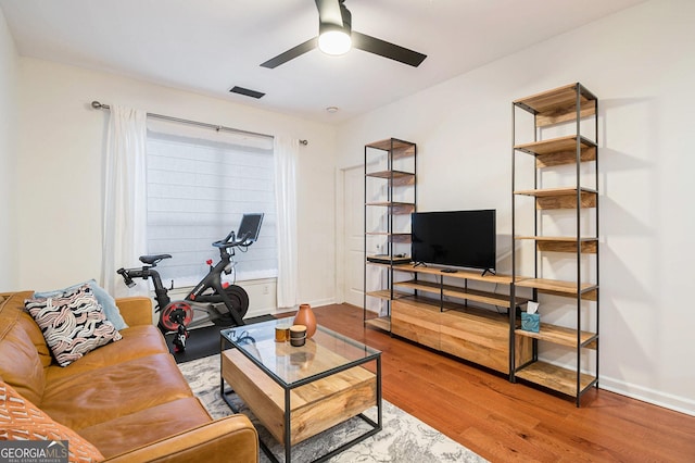 living room with hardwood / wood-style floors and ceiling fan