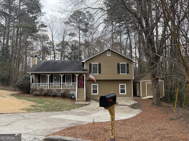 tri-level home with a storage shed and a porch