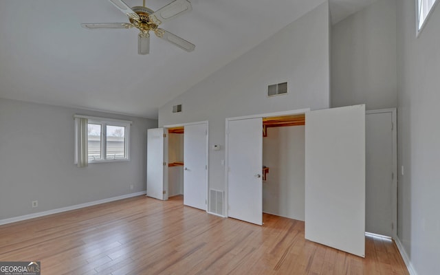 unfurnished bedroom featuring high vaulted ceiling, light wood-type flooring, and ceiling fan