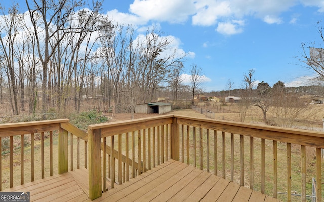 wooden deck with a storage shed and a yard