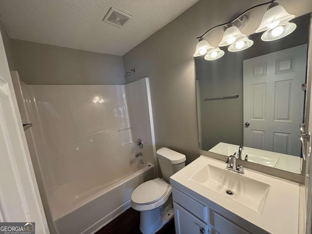 full bathroom with vanity, toilet, shower / bath combination, and a textured ceiling