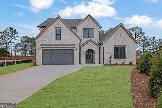 view of front of house featuring a garage and a front yard