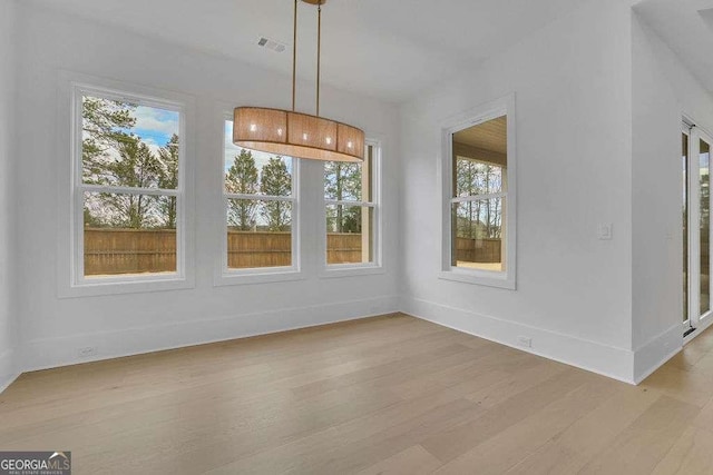 unfurnished dining area with plenty of natural light and light wood-type flooring