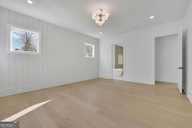 unfurnished room featuring plenty of natural light and light wood-type flooring