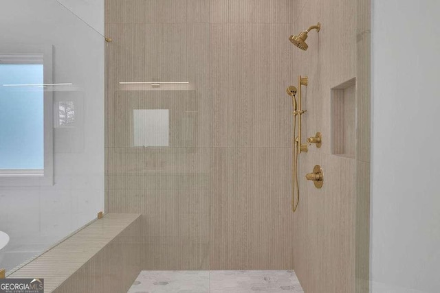 bathroom with a tile shower