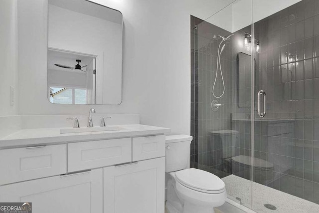 bathroom featuring vanity, ceiling fan, toilet, and walk in shower