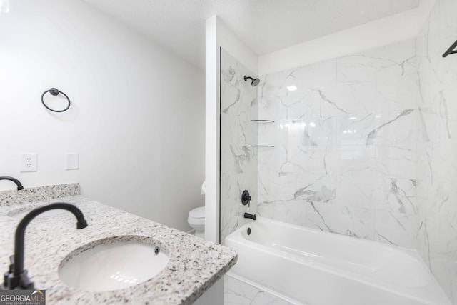 full bathroom featuring vanity, tiled shower / bath combo, and toilet