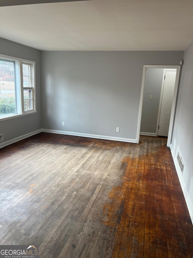 spare room with dark hardwood / wood-style floors