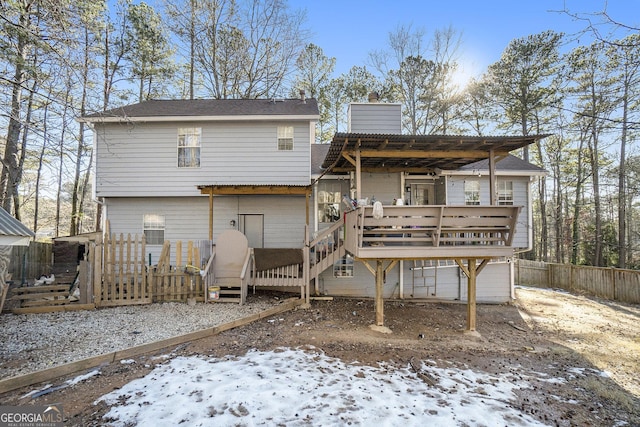 snow covered property featuring a wooden deck