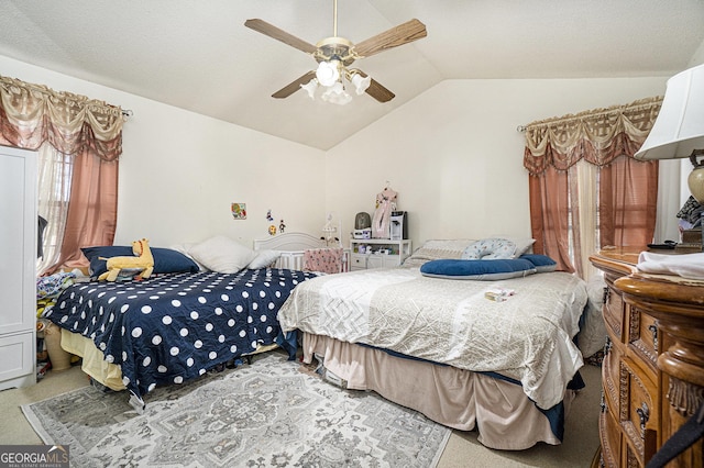 bedroom with ceiling fan, carpet floors, and vaulted ceiling