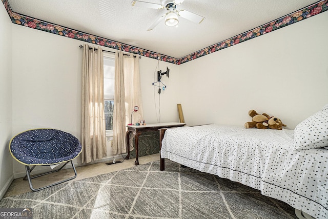 bedroom with a textured ceiling, carpet floors, and ceiling fan