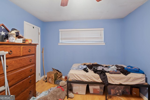 bedroom with light wood-type flooring and ceiling fan