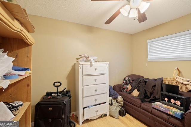 interior space with hardwood / wood-style floors, a textured ceiling, and ceiling fan