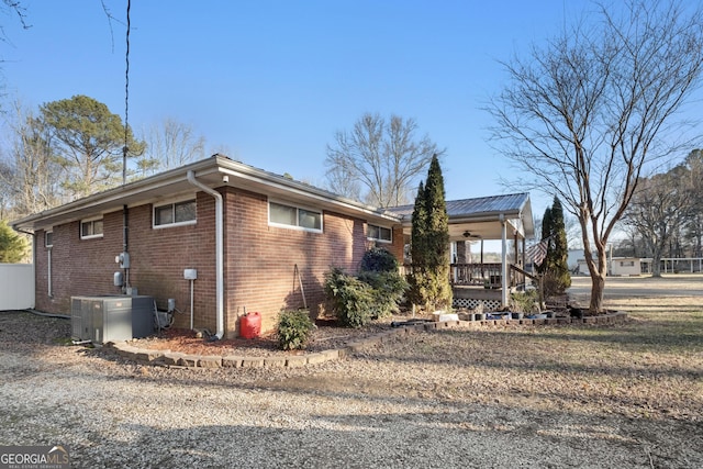 view of side of home featuring central air condition unit and a porch