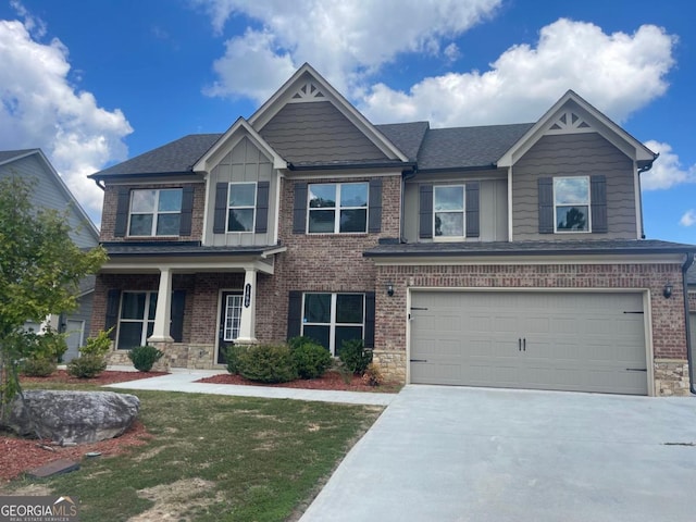 craftsman inspired home with a garage and a front lawn