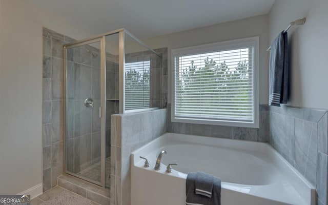 bathroom featuring independent shower and bath and a healthy amount of sunlight