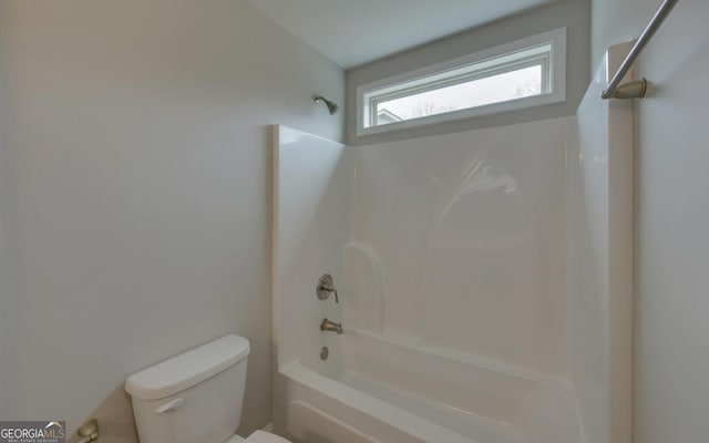 bathroom featuring toilet and shower / bathing tub combination