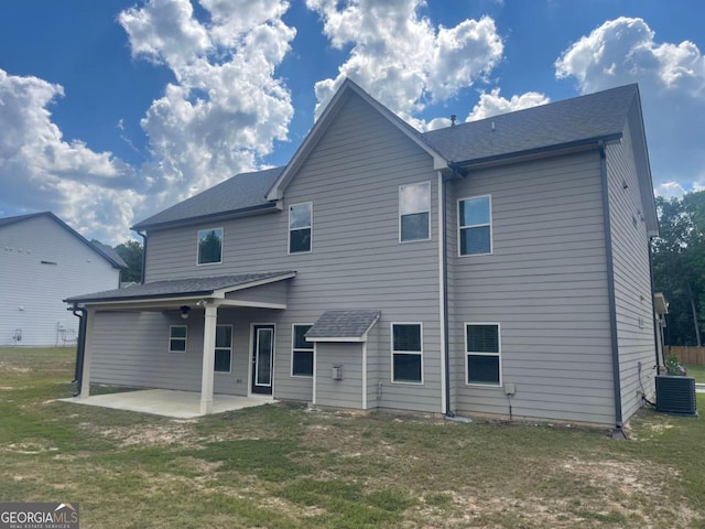 rear view of house featuring a patio and a lawn